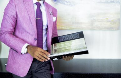 Man in Pink Suit Jacket Holding Book